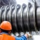 Technician inspecting a large industrial machine component
