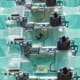 Electronic assemblies arranged in trays for manufacturing production